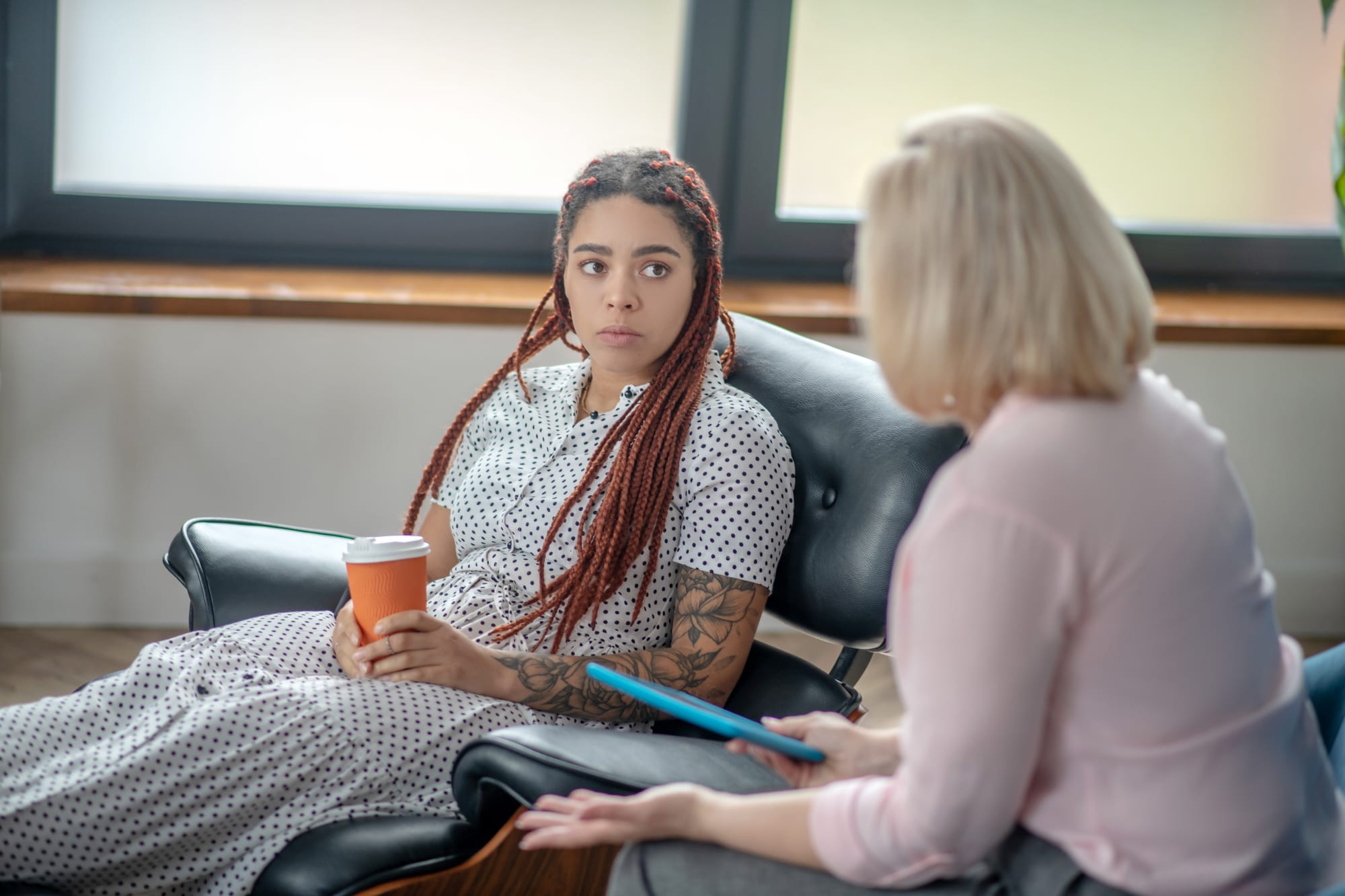 Personal issues. Young woman with dreads talking to the psychologist